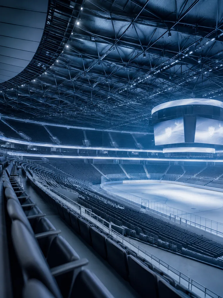 The interior of a large modern arena with sweeping empty seating